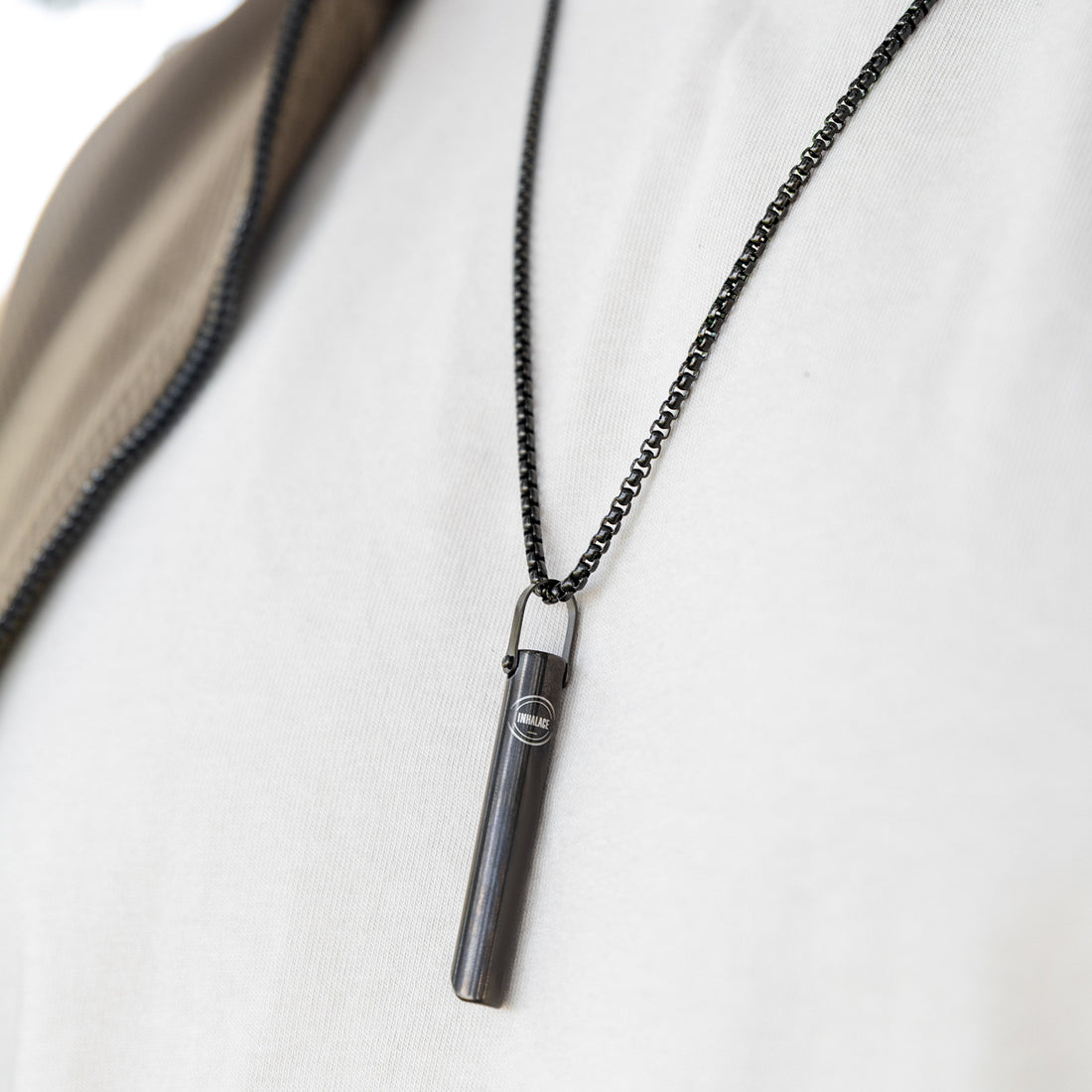 Person using an Inhalace breathing necklace during a break